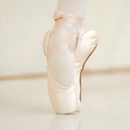 TwooDoo - Füße einer Ballerina auf der Spitze.